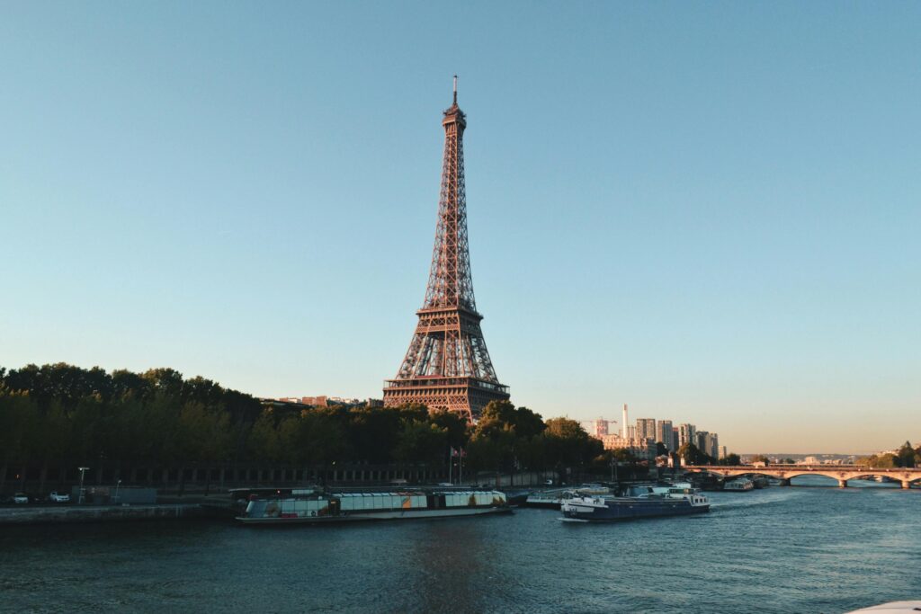 pexels-photo-2082103-2082103 Scenic view of the Eiffel Tower and Seine River at sunset, showcasing iconic Parisian architecture.