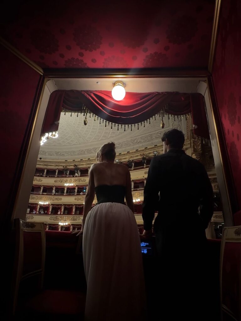Elegant couple at an opera house in evening attire during winter