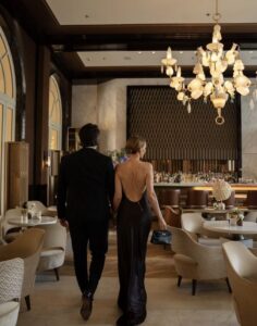 Elegant people arriving to the restaurant after an evening at the opera 