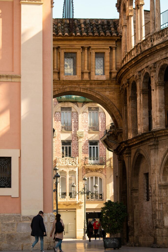 Beautiful stone arches and historic buildings in Valencia's old town, Spain.